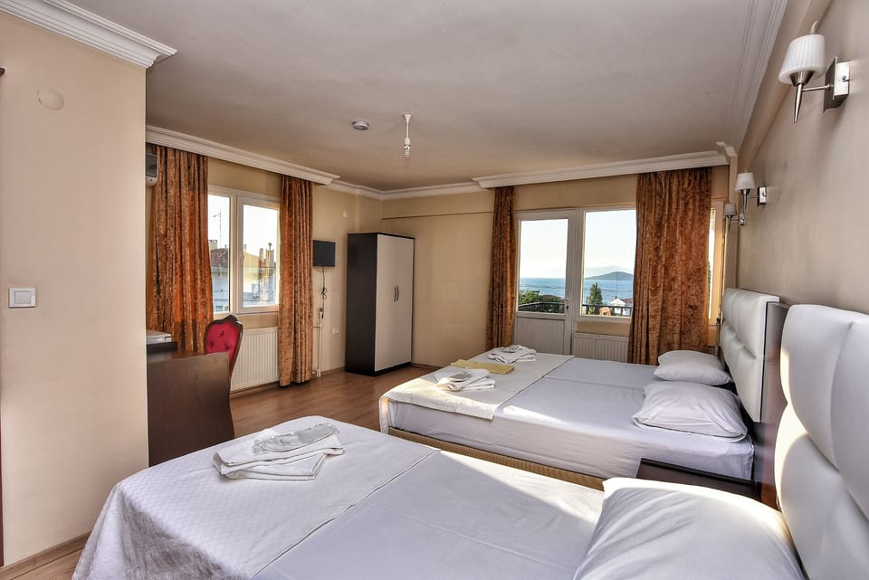 Family Triple Room, Sea View | Premium bedding, minibar, desk, free WiFi