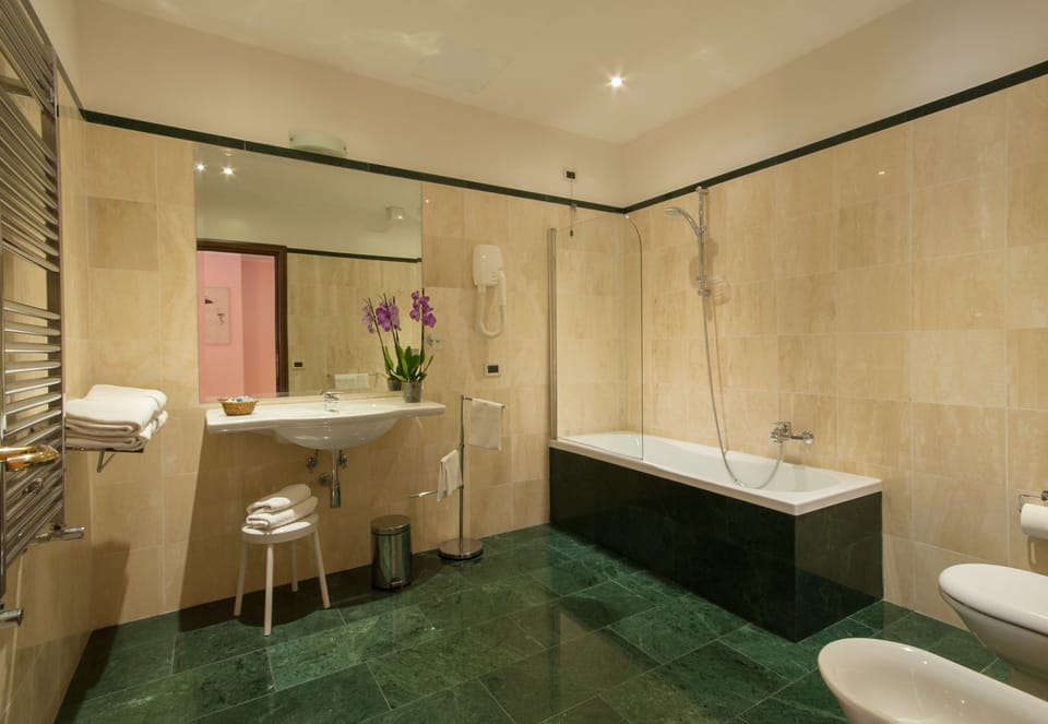 Quadruple Room | Bathroom | Hair dryer, towels