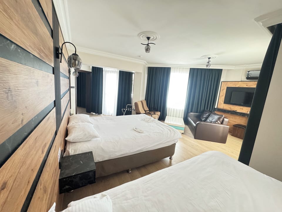 Deluxe Quadruple Room, Non Smoking | Premium bedding, minibar, soundproofing, iron/ironing board
