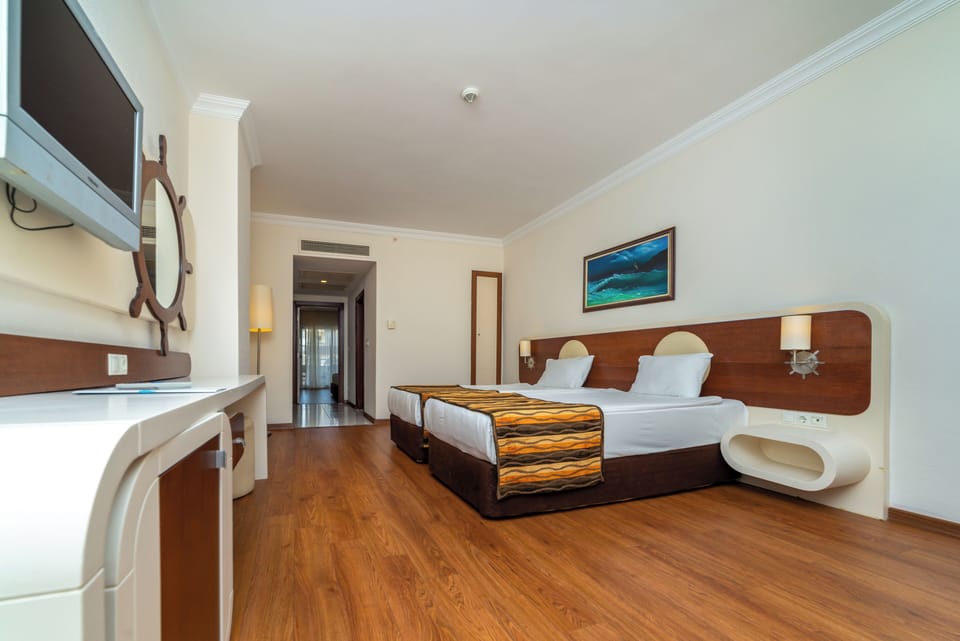 Family Room | Free minibar, in-room safe, desk, laptop workspace