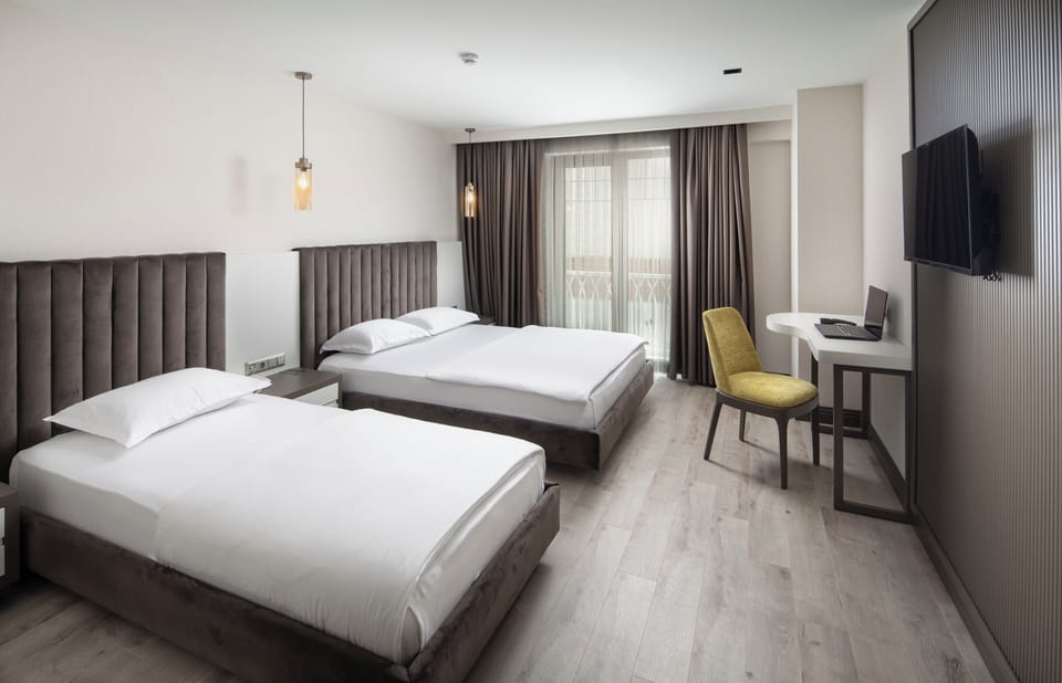 Triple Room | Minibar, in-room safe, desk, soundproofing