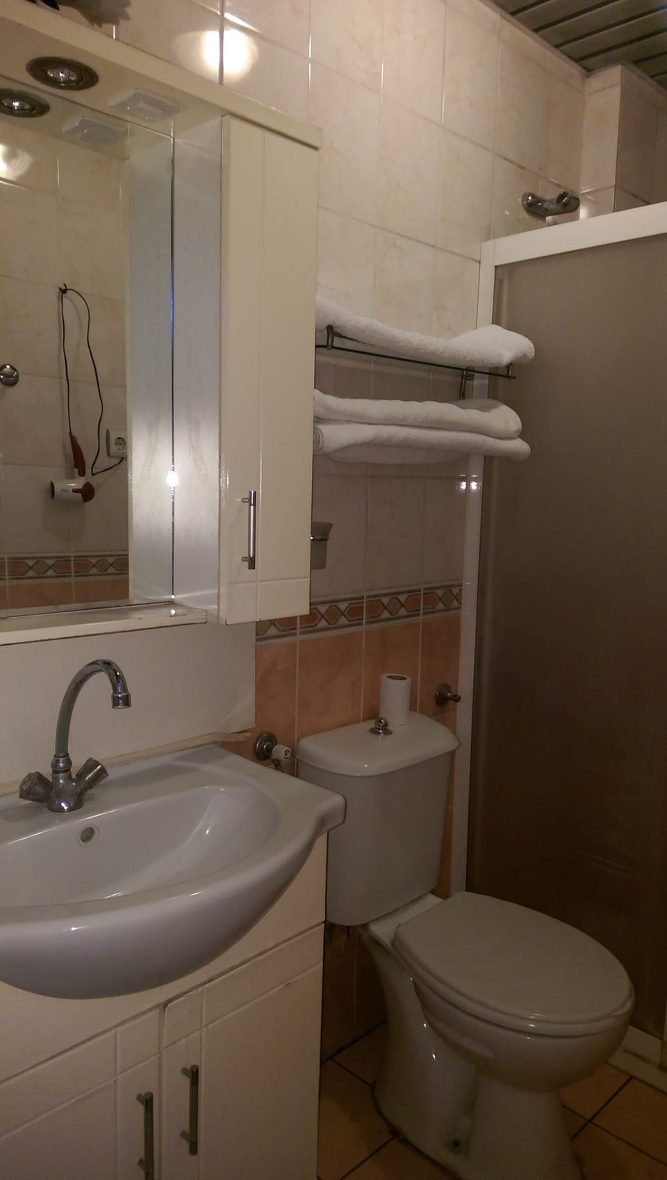 Shower, hair dryer, slippers, towels