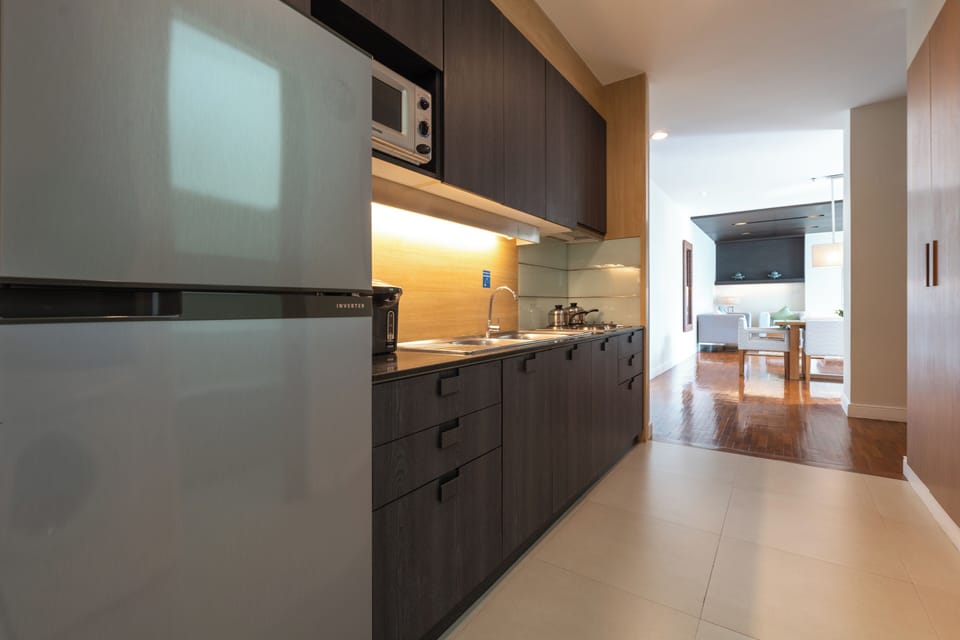 Two-Bedroom Suite | Private kitchen | Fridge, electric kettle, dining tables