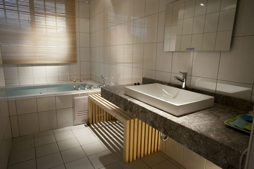 Family Room, 1 Bedroom | Bathroom | Hydromassage showerhead, hair dryer, slippers, towels