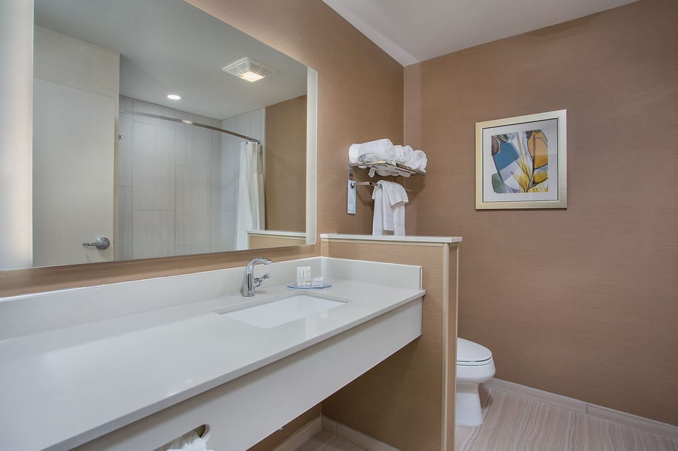 Designer toiletries, hair dryer, towels