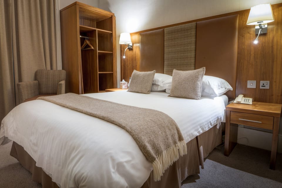 Hypo-allergenic bedding, desk, laptop workspace, blackout drapes