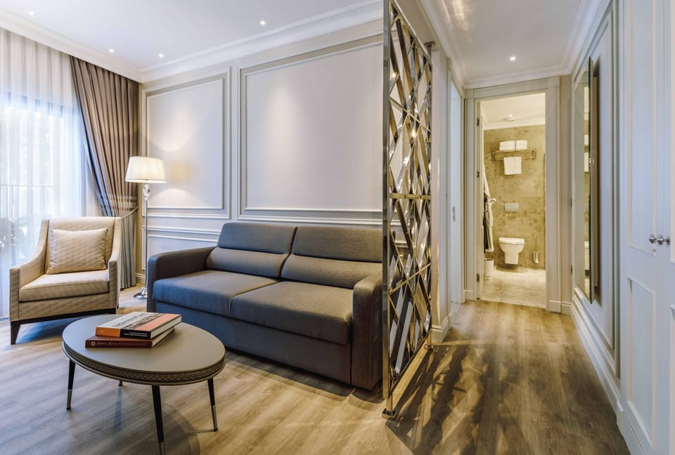 Deluxe Suite | Living room | 52-inch LCD TV with cable channels, TV, heated floors