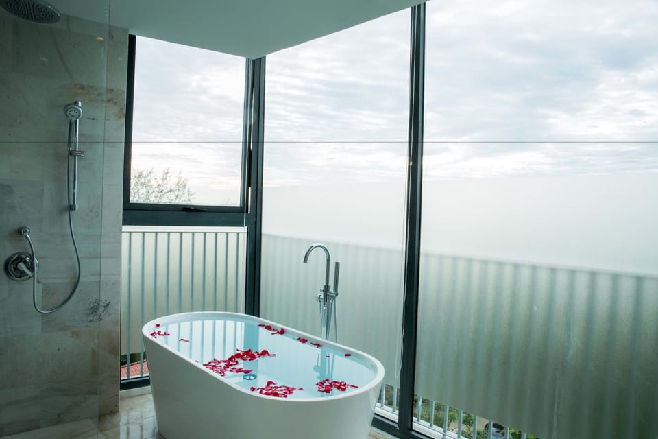 Shower, designer toiletries, hair dryer, slippers