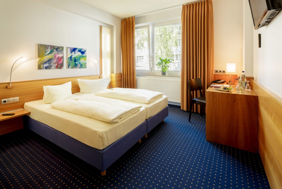 Standard Double or Twin Room | In-room safe, desk, laptop workspace, blackout drapes
