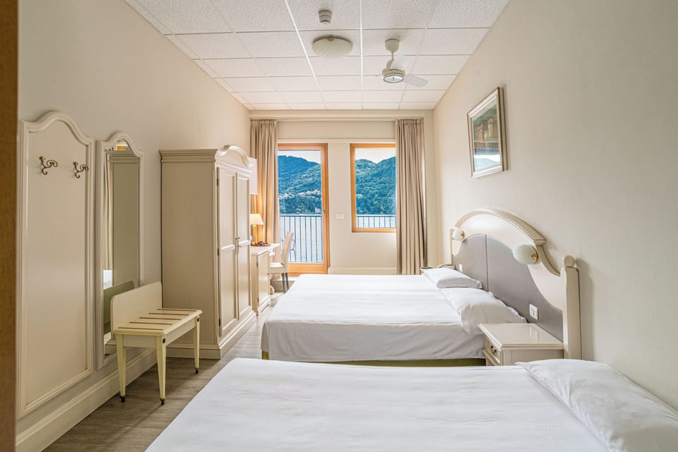 Triple Room, Balcony, Lake View | Down comforters, in-room safe, individually decorated, desk