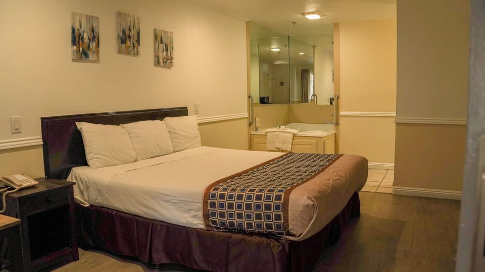 Room, 1 King Bed, Jetted Tub | Iron/ironing board, rollaway beds, free WiFi, bed sheets