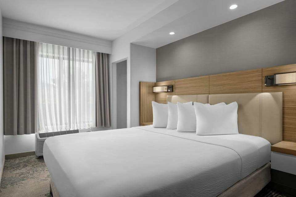 Premium bedding, desk, laptop workspace, blackout drapes