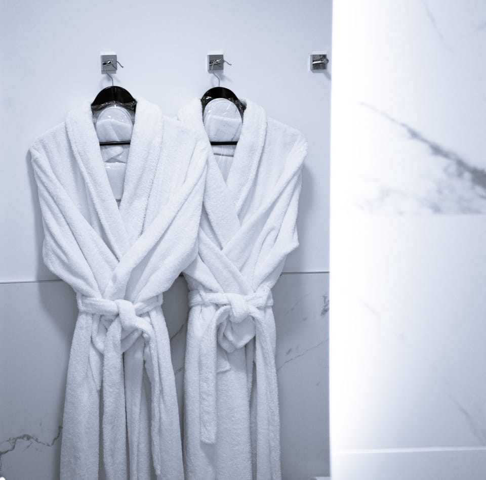 Shower, designer toiletries, hair dryer, bathrobes