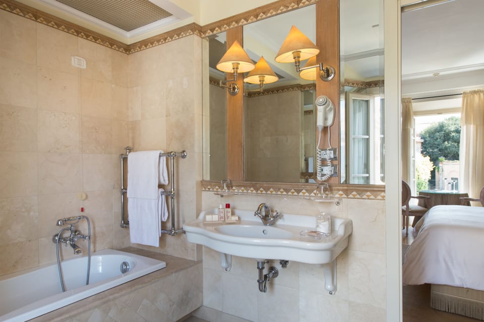 Deluxe Double Room, City View | Bathroom | Combined shower/tub, free toiletries, hair dryer, bathrobes