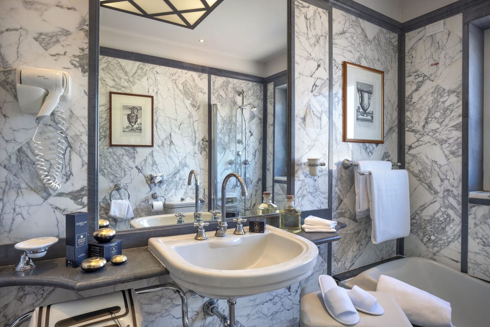 Combined shower/tub, designer toiletries, hair dryer, slippers