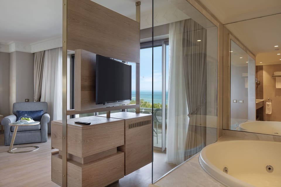 Deluxe Suite, Sea View | Bathroom | Rainfall showerhead, designer toiletries, hair dryer, bathrobes