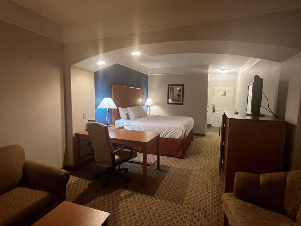 Premium bedding, desk, laptop workspace, blackout drapes