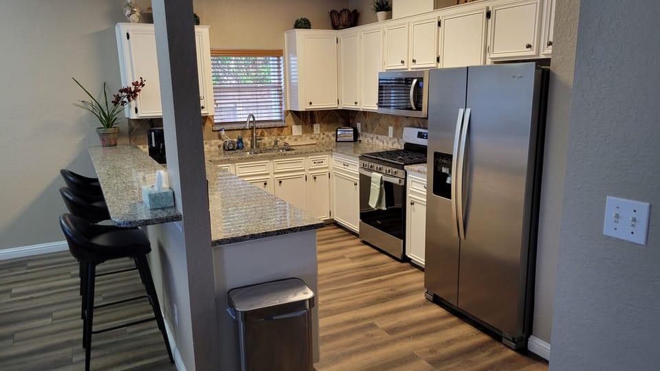 Kitchen with marble counter tops and stainless appliances!