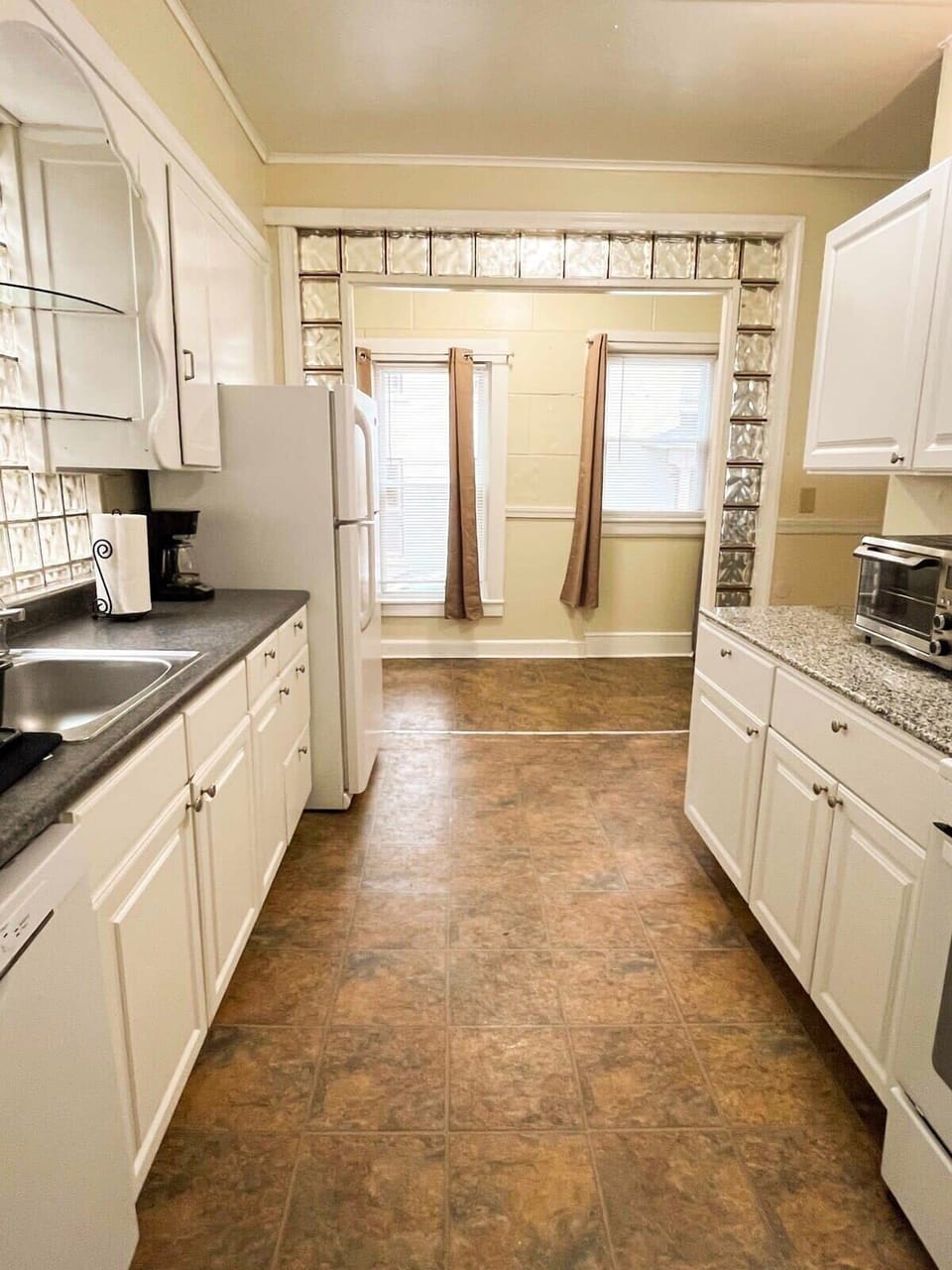 The fully equipped kitchen, with the back door that leads to the back deck and grill.