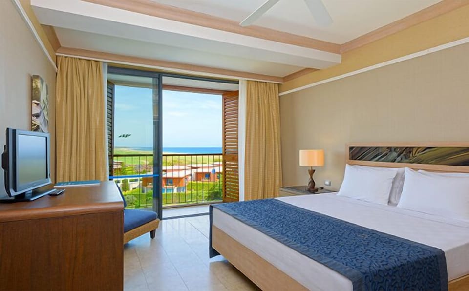 Family Room, Pool Access, Partial Sea View | 1 bedroom, free minibar, in-room safe, blackout drapes
