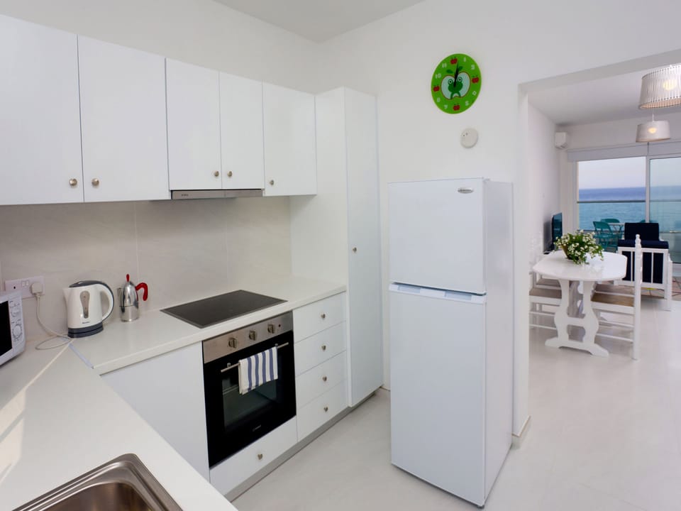 Deluxe Apartment, 2 Bedrooms, Beachfront | Private kitchen | Full-size fridge, microwave, oven, stovetop