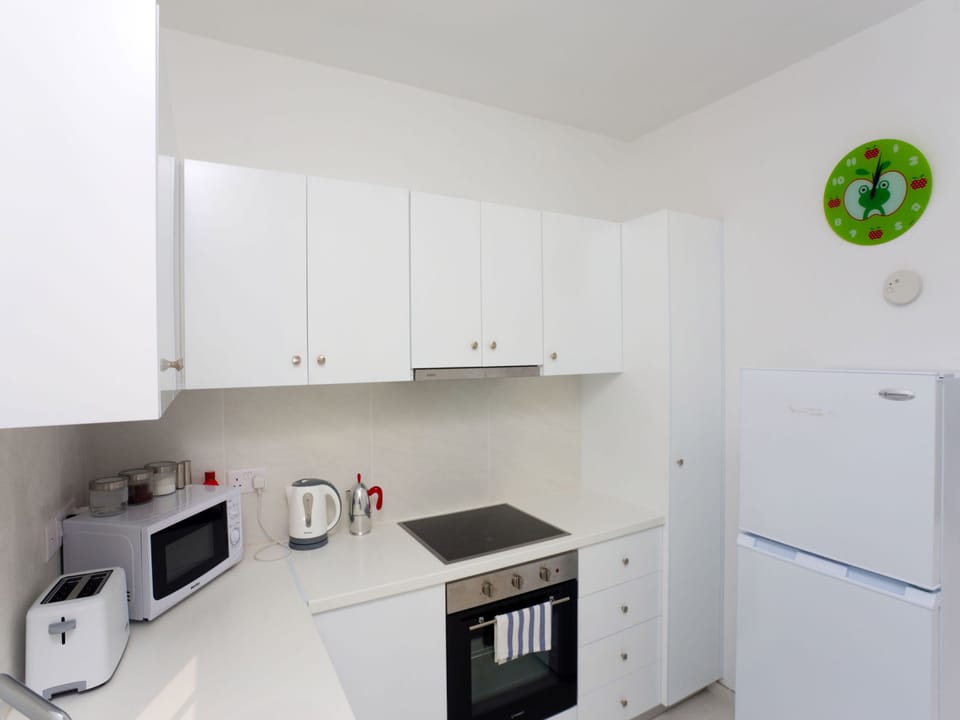 Deluxe Apartment, 2 Bedrooms, Beachfront | Private kitchen | Full-size fridge, microwave, oven, stovetop
