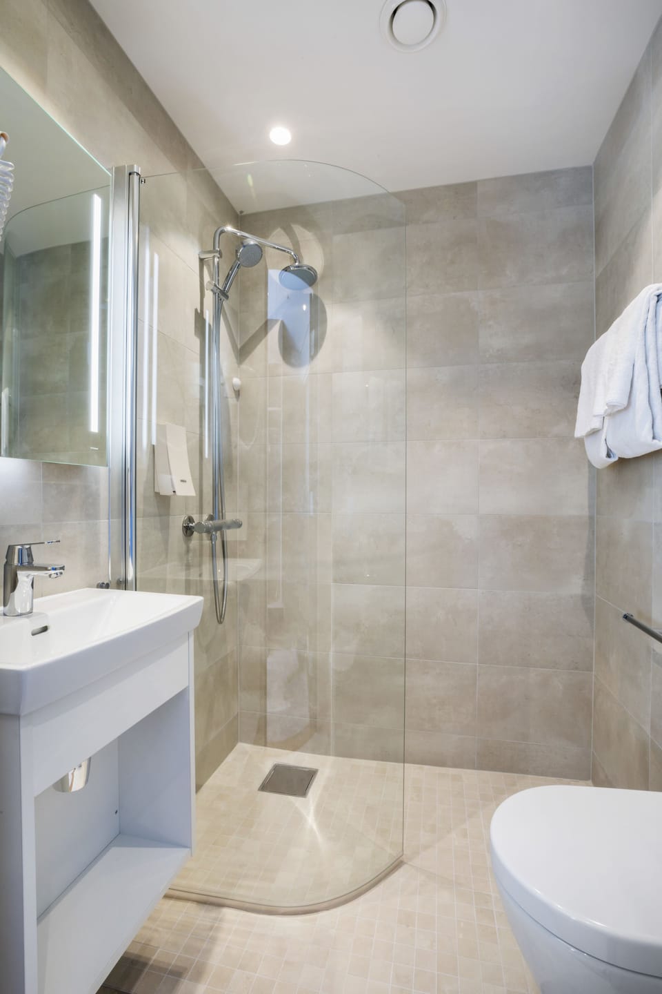 Shower, rainfall showerhead, hair dryer, towels