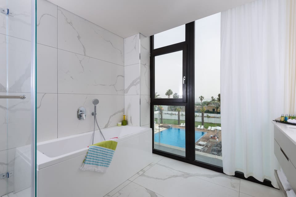 Shower, designer toiletries, hair dryer, bathrobes
