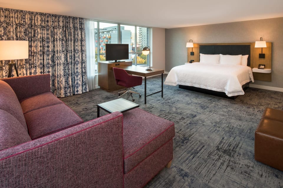 Hypo-allergenic bedding, desk, laptop workspace, blackout drapes