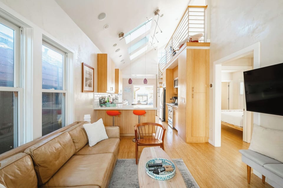 Walk into a light and bright open concept living room with soaring ceilings and skylights bringing the outside into the comfortable space.