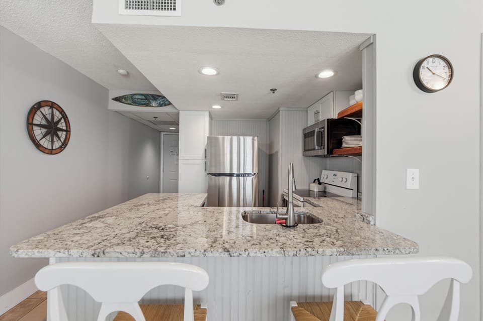 Kitchen with bar and bar stools