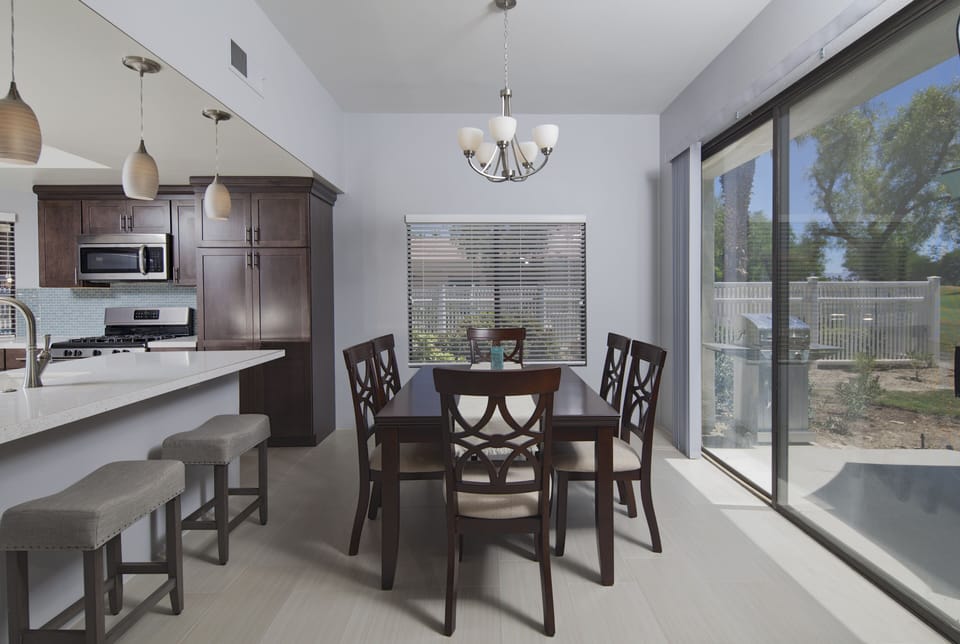 Dining area with seating for six, golf course views and BBQ right outside