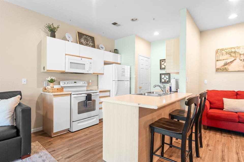 Breakfast bar and open kitchen layout keep meals, snacks, and conversation flowing easily.