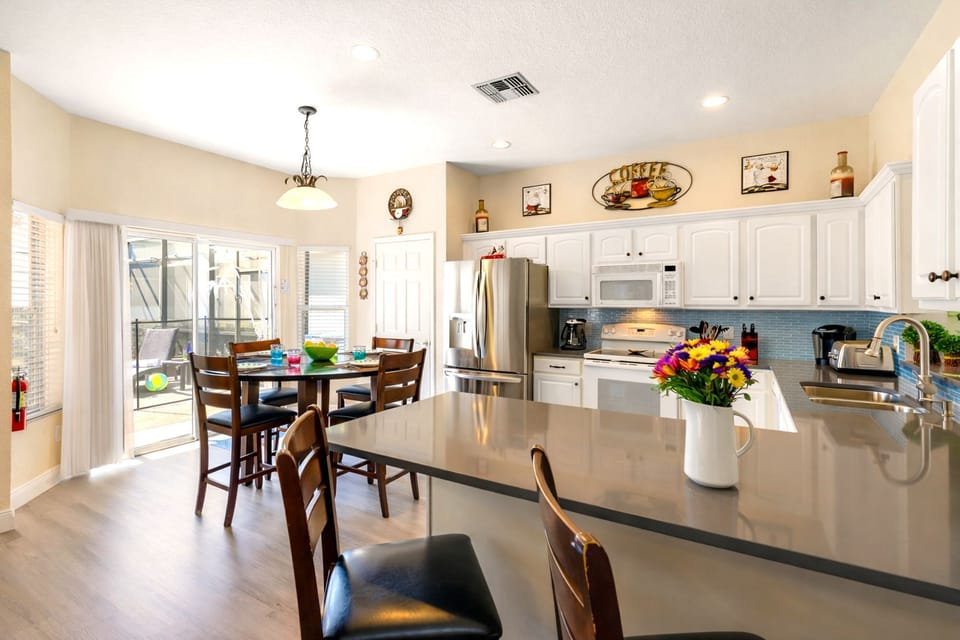The kitchen seats two at the bar and four in the nook that overlooks the pool