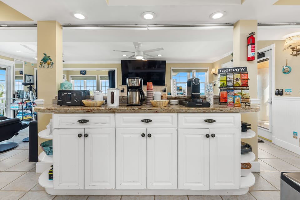 Hot-beverage station with a Nespresso machine, coffee maker, & selection of teas