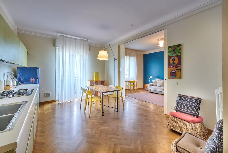 View of the dining area and the living room in the background from the entrance.