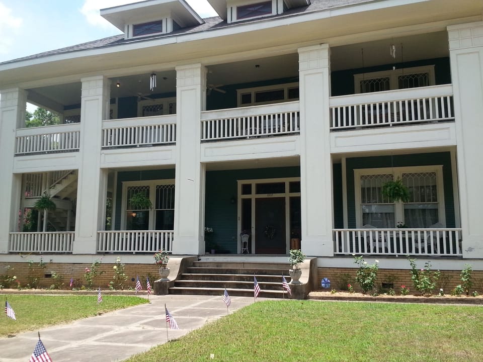 Street view of Historic Hole House on half acre lot, near downtown.