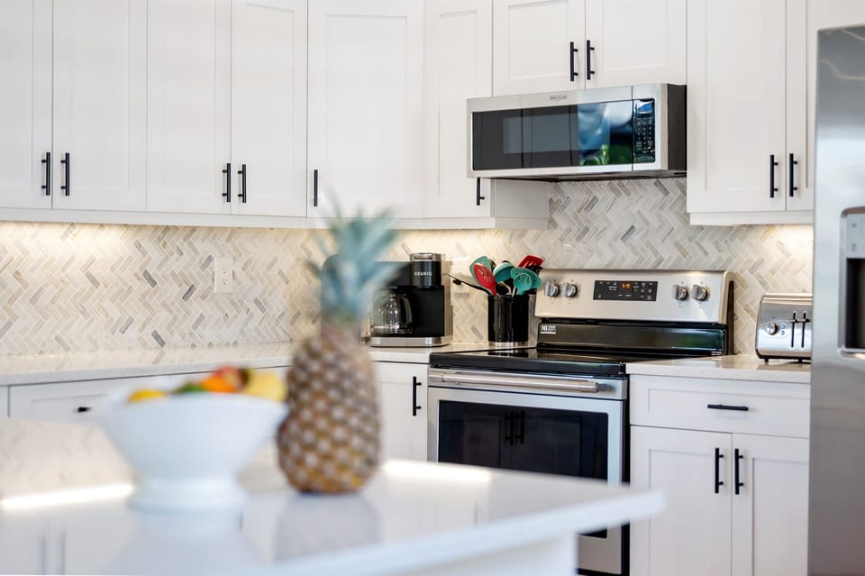 Sleek design meets beachy charm in this bright, modern kitchen