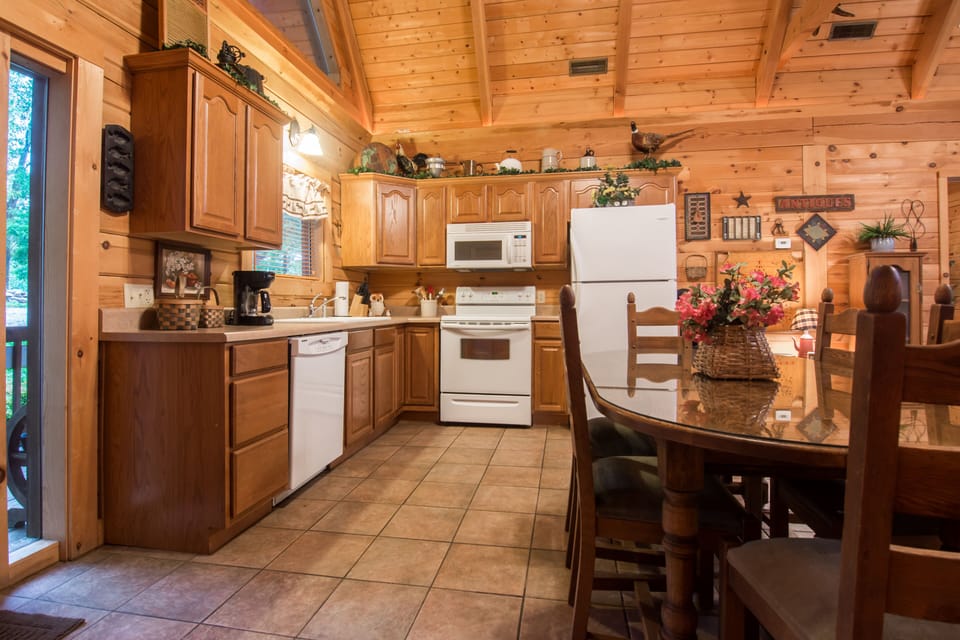 Kitchen with refrigerator, stove, microwave, & dishwasher.