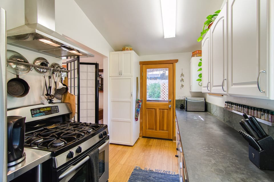 Kitchen door to back yard affords climatic flow to enjoy your meals al fresco.