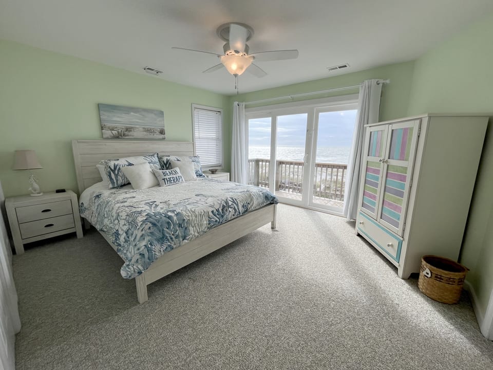 Master featuring a king bed with oceanfront views, private balcony & ensuite