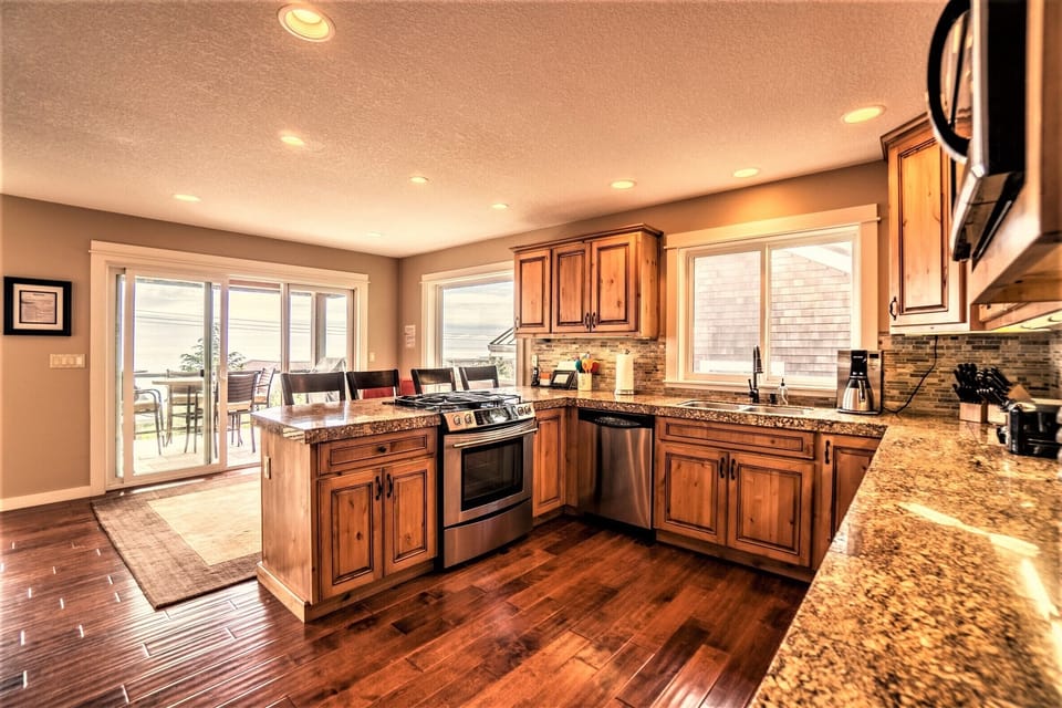 Open kitchen w/easy access to deck with grill and incredible views as you cook!