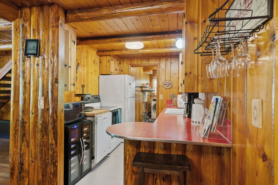 Fully stocked kitchen with dishwasher, microwave, range, and fridge/freezer