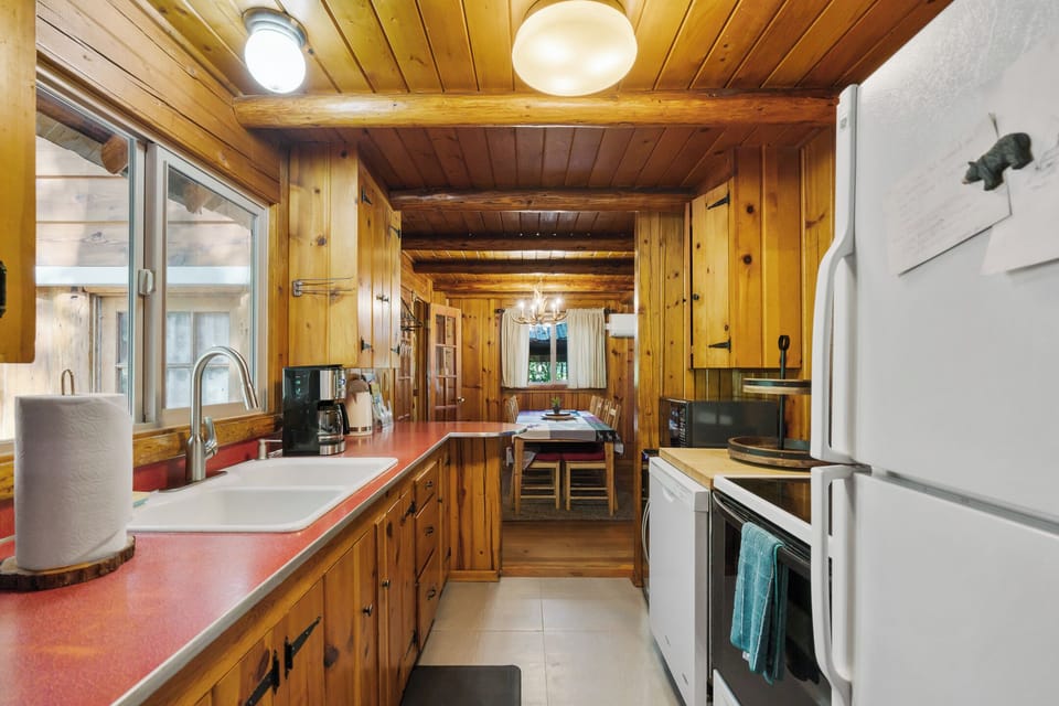 Fully stocked kitchen with dishwasher, microwave, range, and fridge/freezer