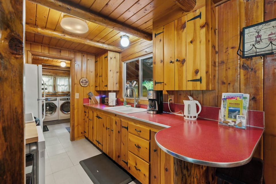 Fully stocked kitchen with dishwasher, microwave, range, and fridge/freezer