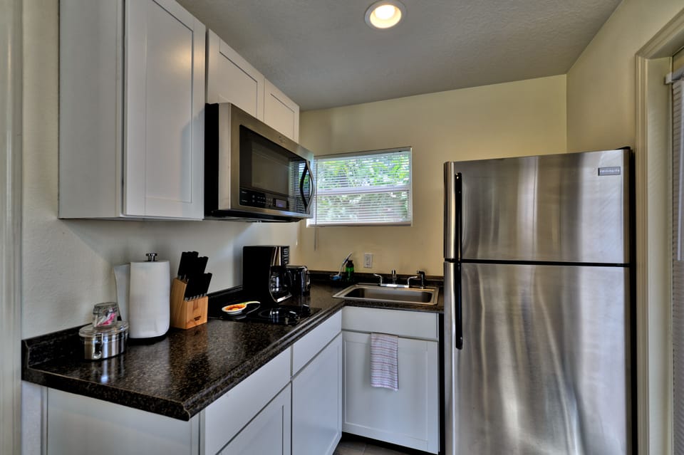 Kitchen with glass top burner, coffee maker, convection microwave, sink & etc
