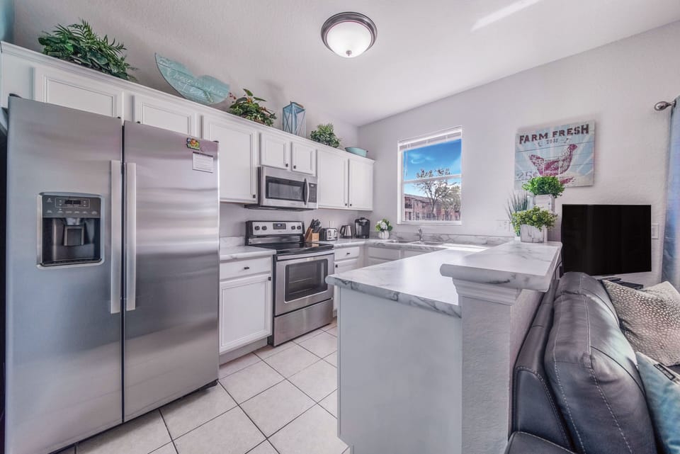 This bright, white, coastal kitchen has everything you need for your stay.