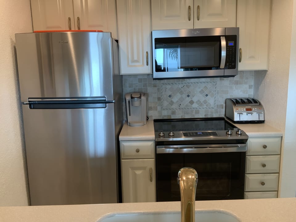 Kitchen has stainless appliances, Fiesta cookware Keurig coffee maker