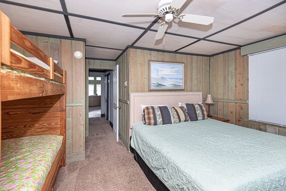 Bedroom with king bed and bunk beds.