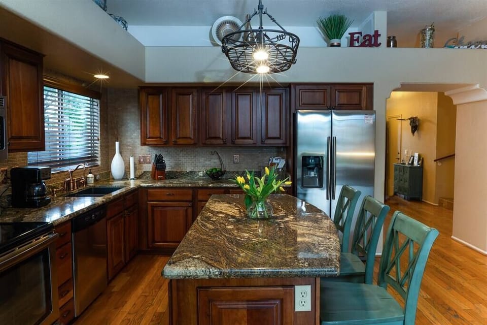 Fully stocked kitchen with stainless appliances and granite counters